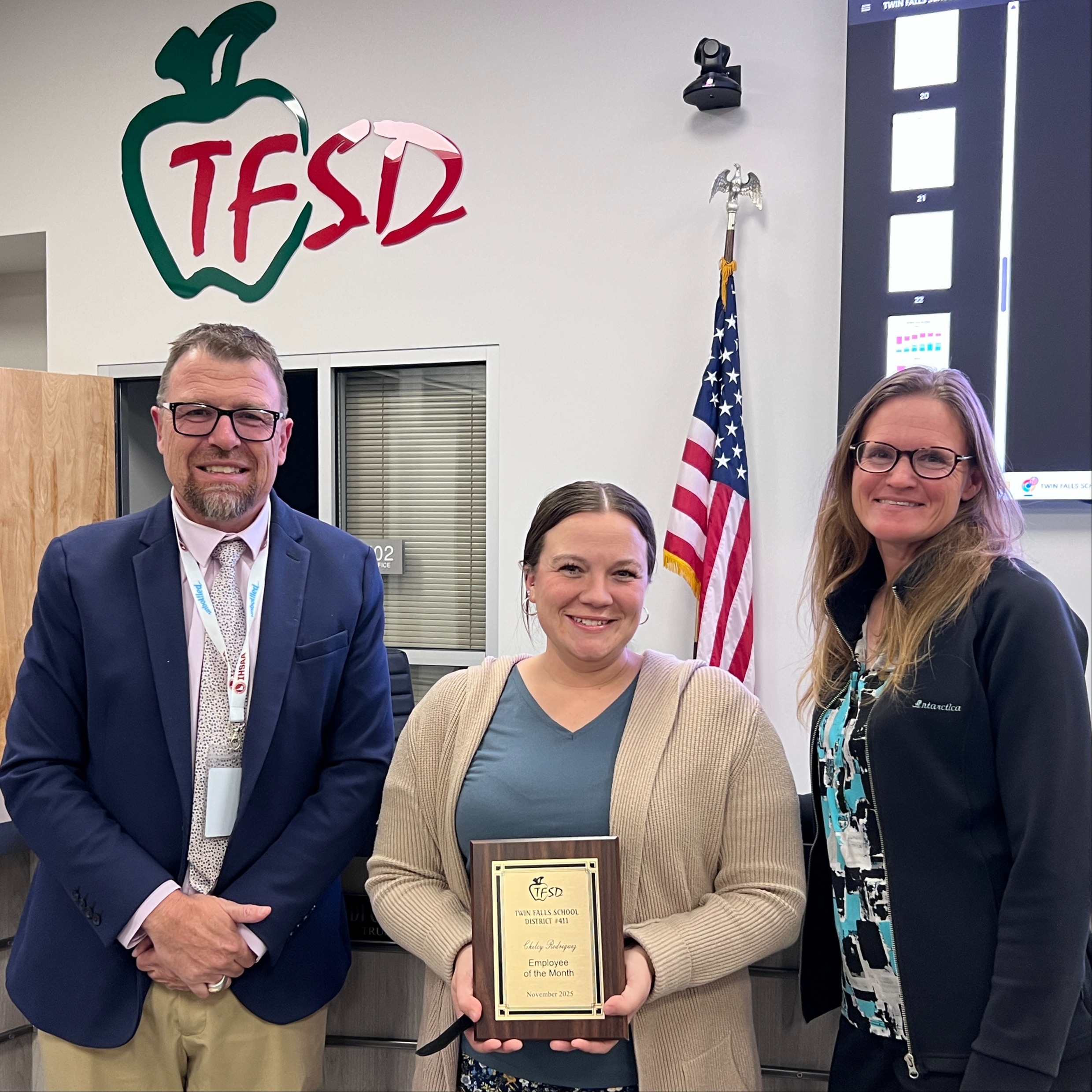 Chelcy Rodriguez receives a plaque from Dr. Dickinson and a School Board  trustee.