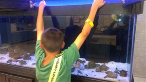 student holding aquarium