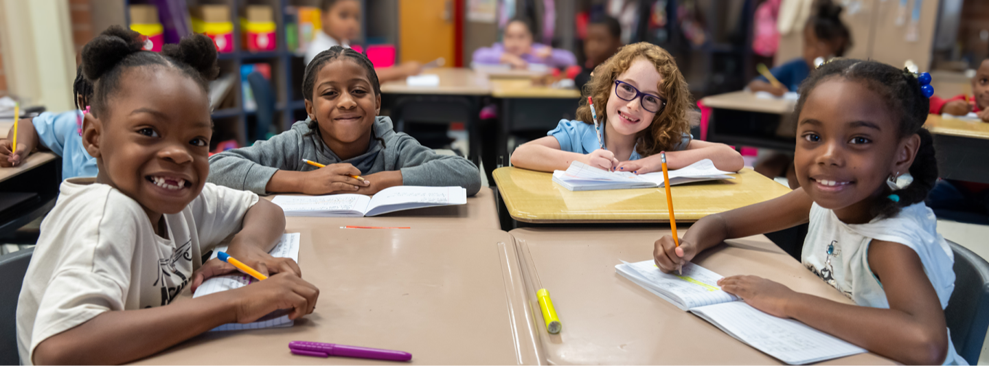 students posing at desk