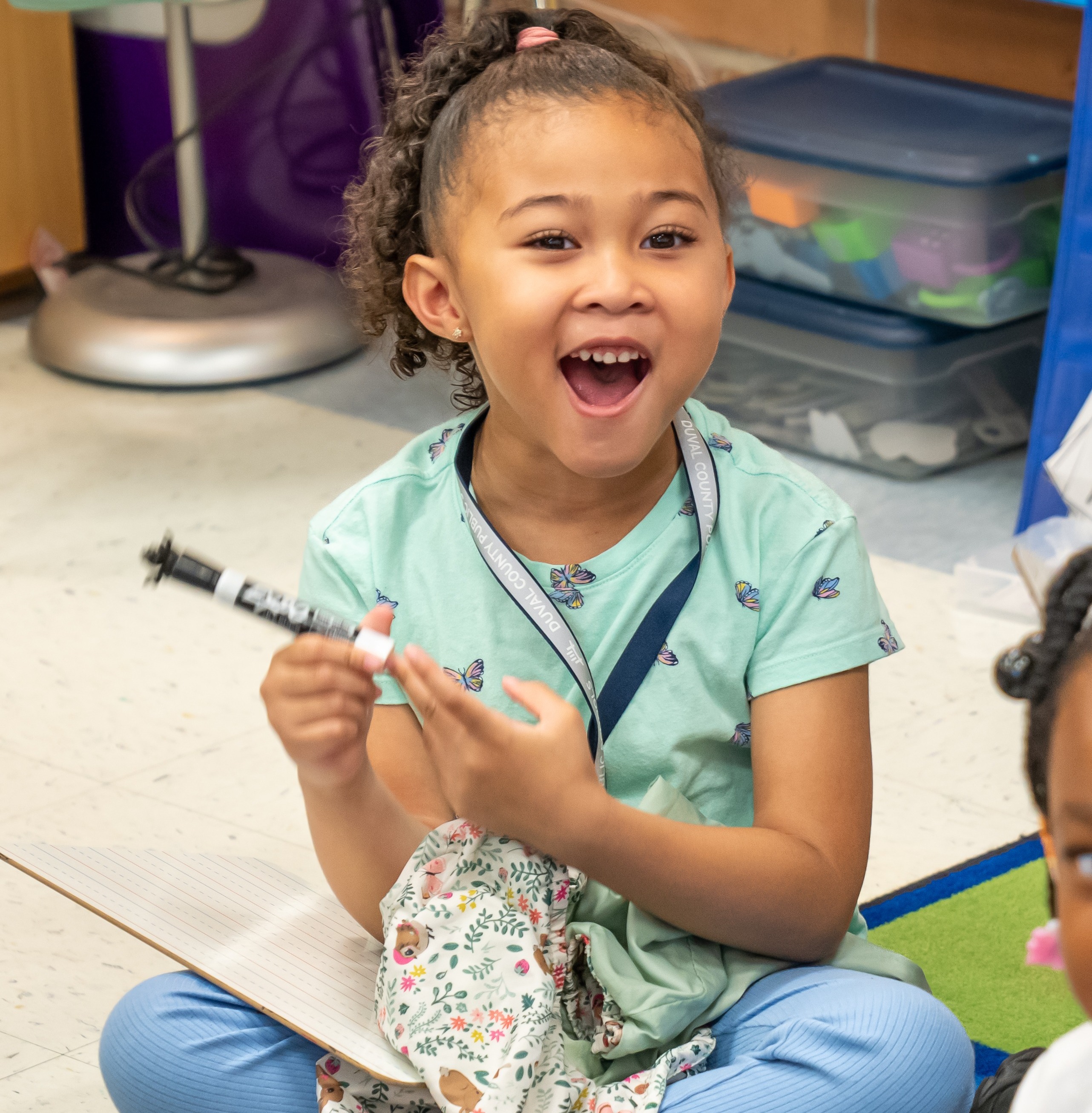 Famale student sitting on a carpet in the classroom