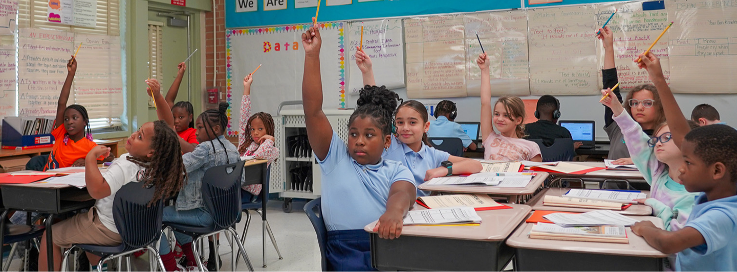 students raising hands