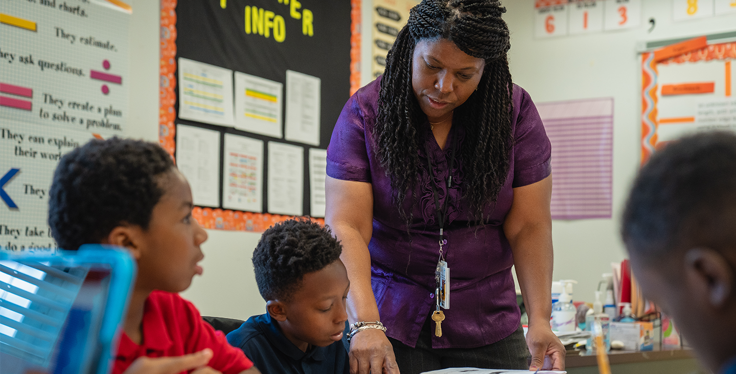 teacher giving students guidance on a lesson