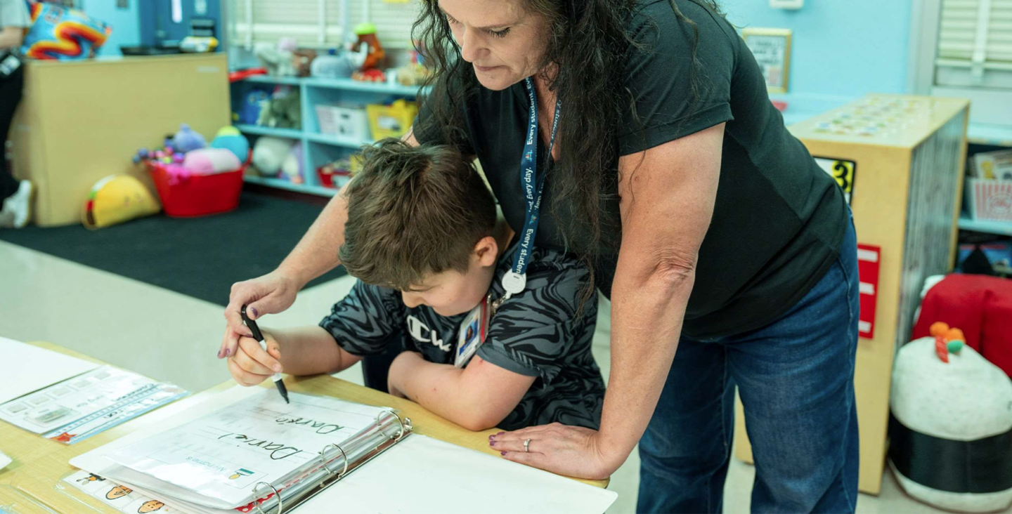 student and teacher working on handwriting skills