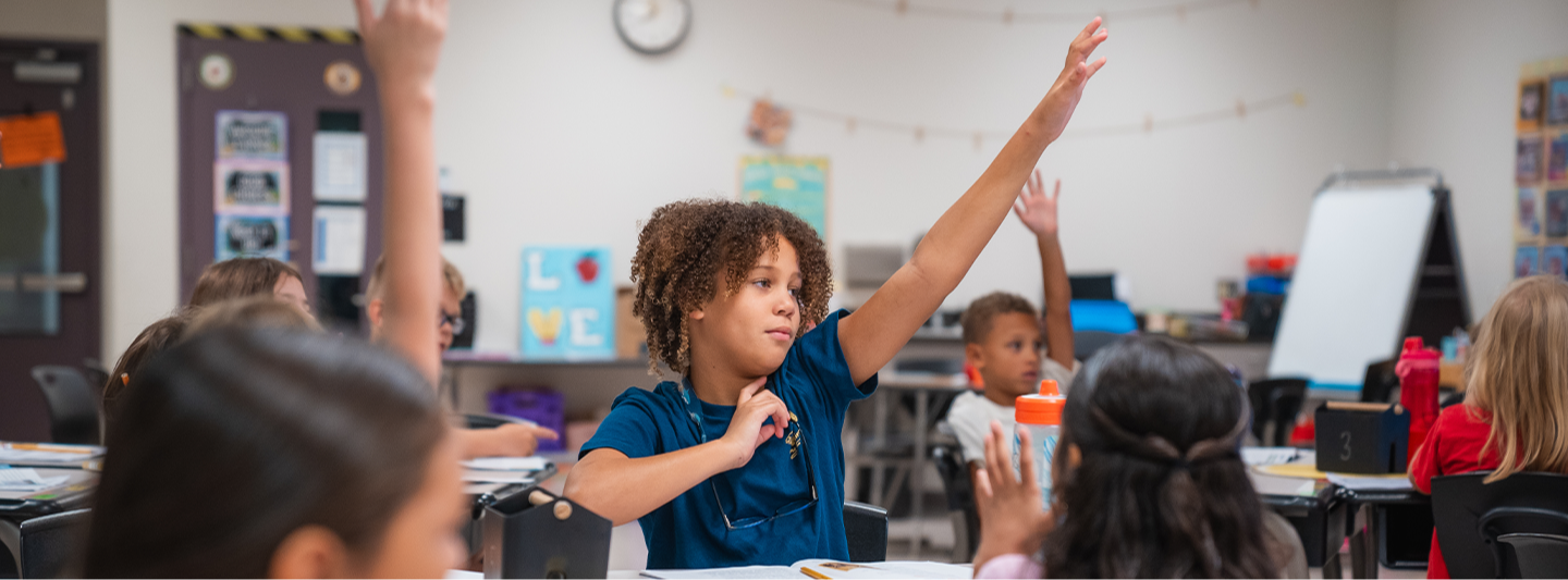 students raising hands