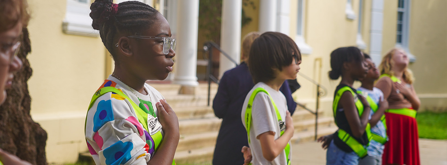 students in safety belts pledging allegiance