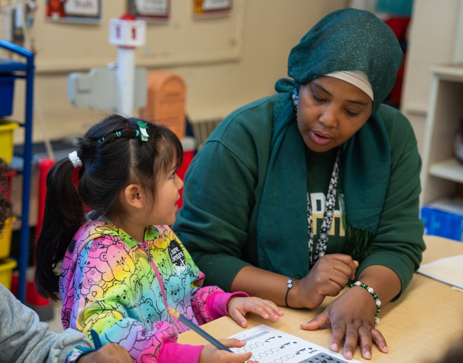 A teacher helping a student