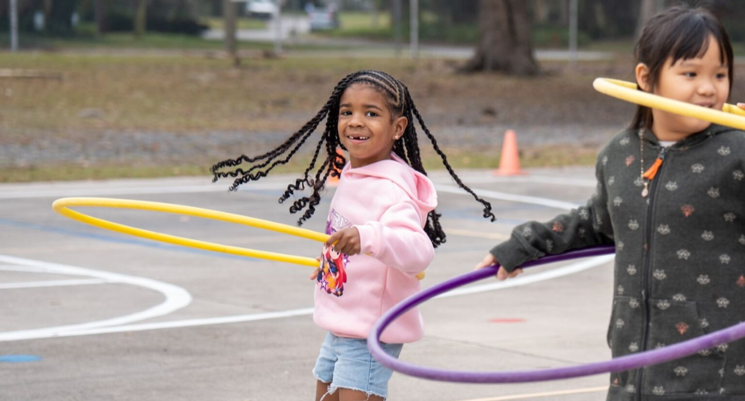 Student smiling and hula hooping