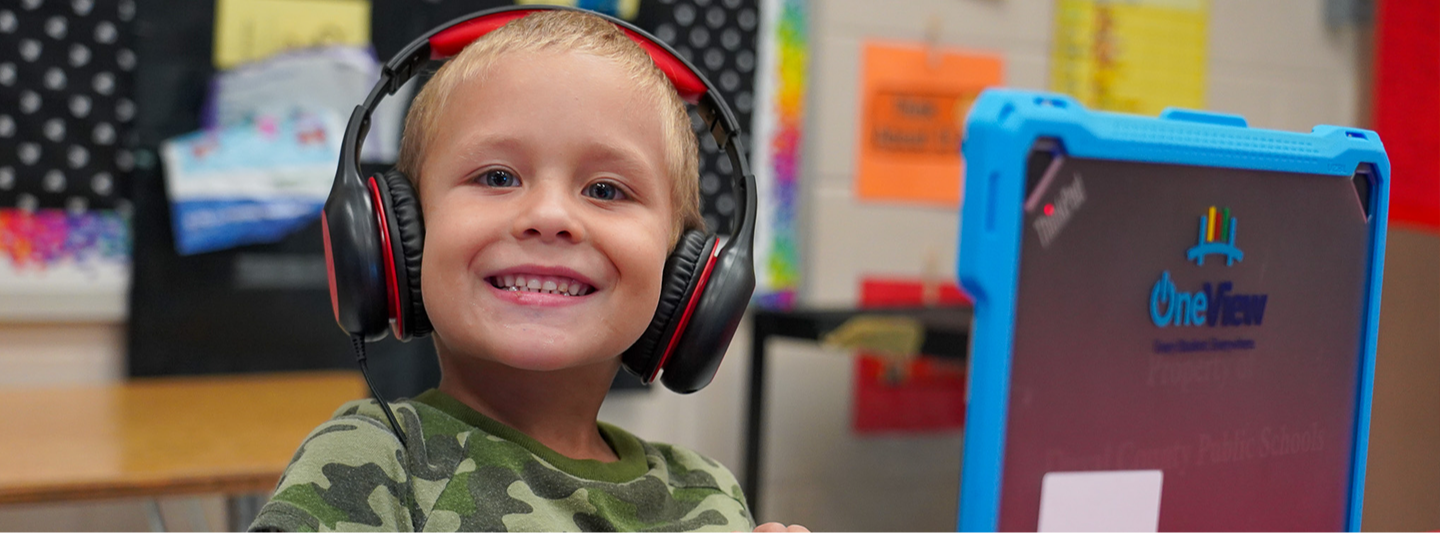 student smiling with headphones