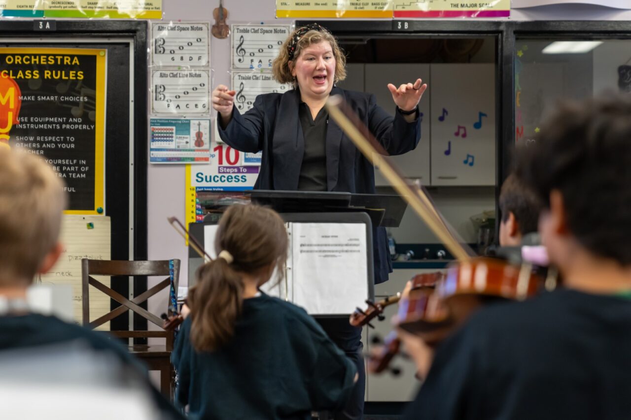 Teacher conducting a strings class