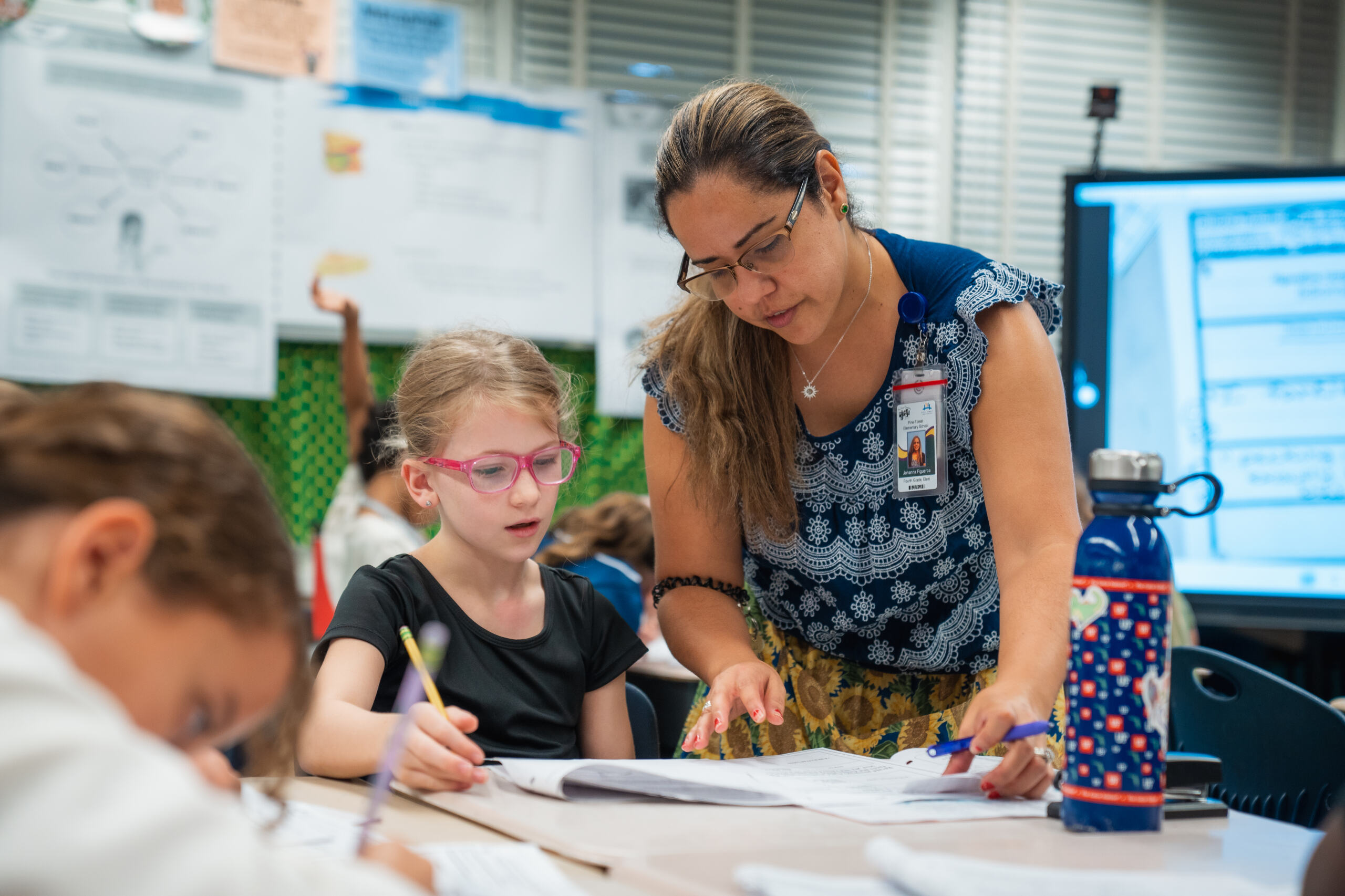 A teacher helping a student on an assignment