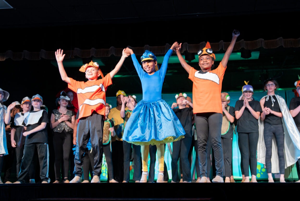 Students dressed up as Nemo, Dory, and Marlin center stage ready to take a bow