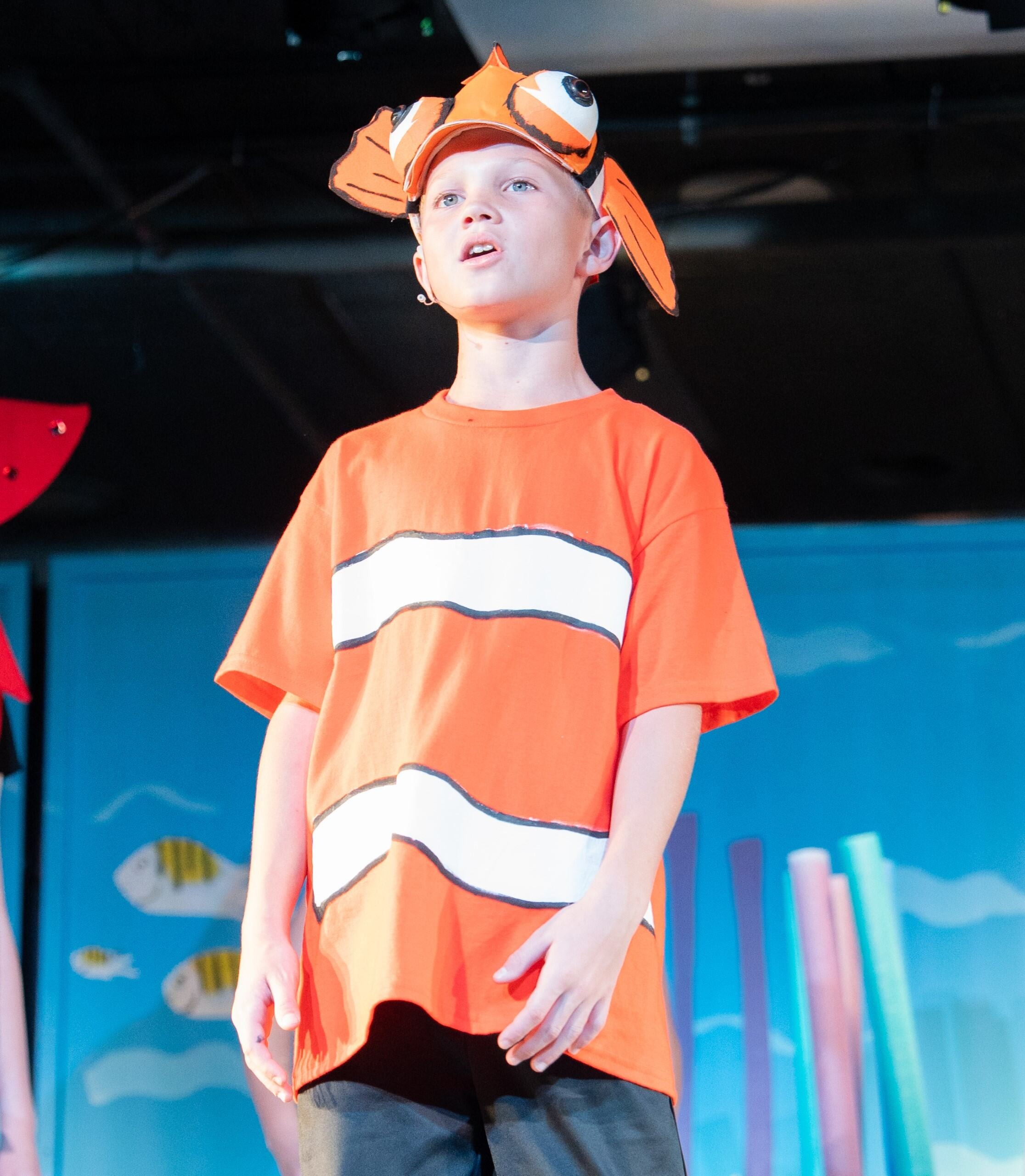 Student dressed as Nemo, on stage singing