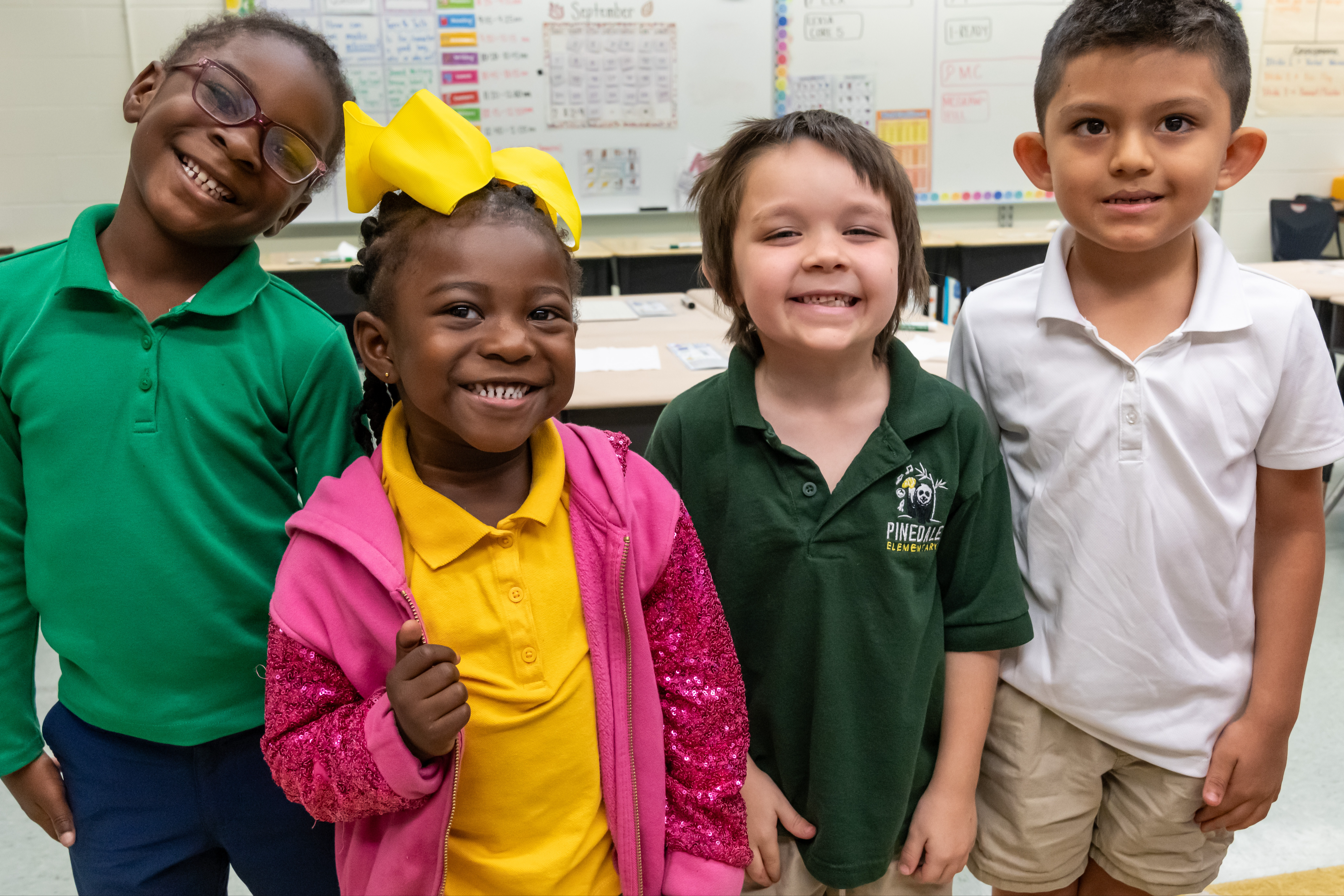 Four students smiling in class