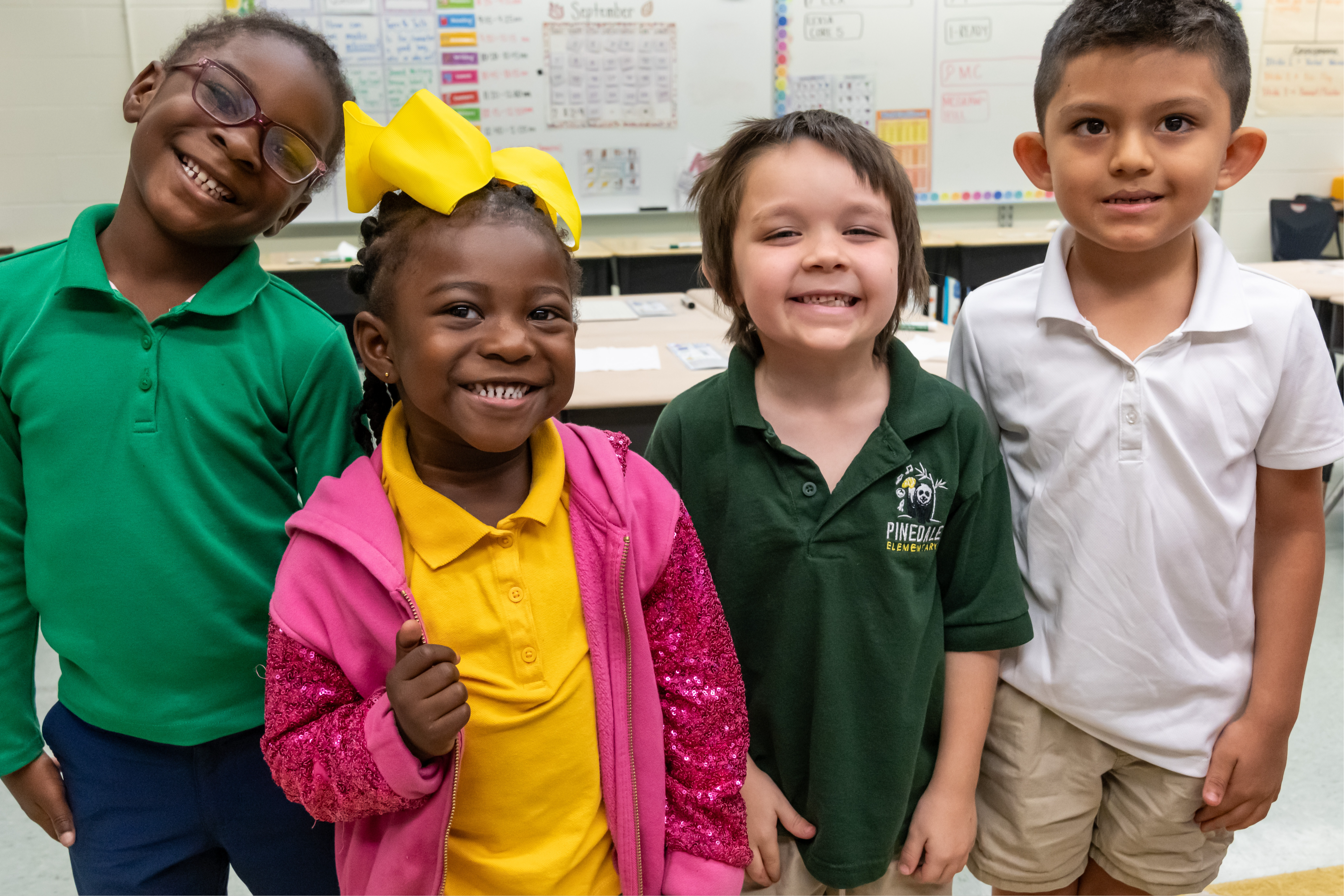 Four students smiling in class