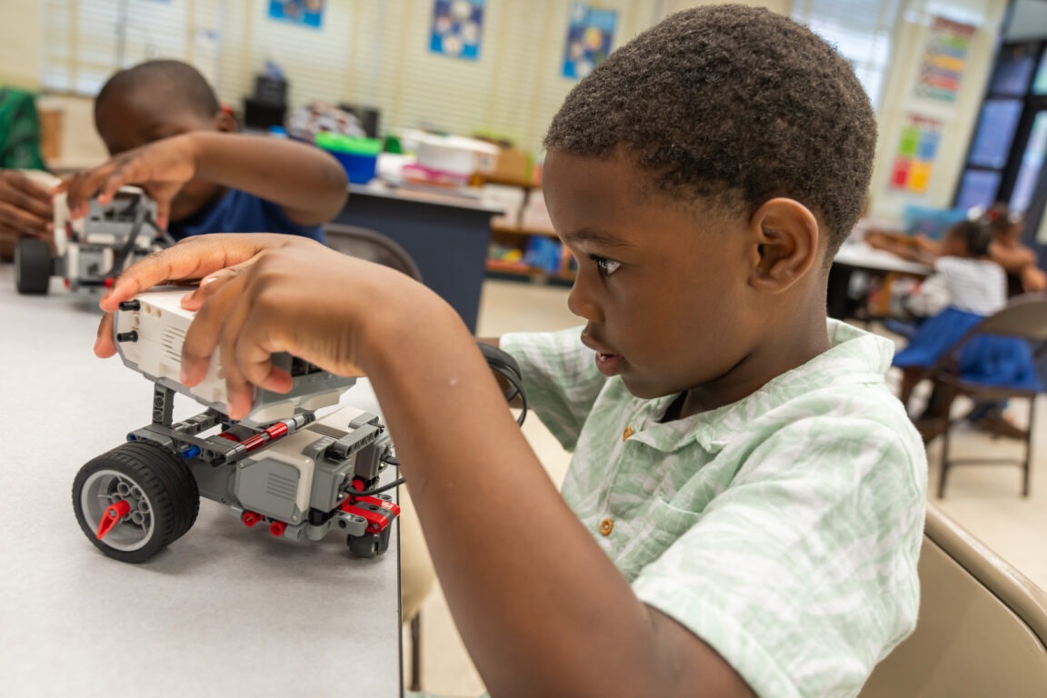 Student playing with robotics