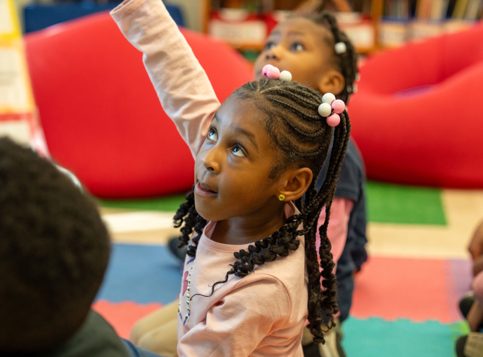 student raising her hand