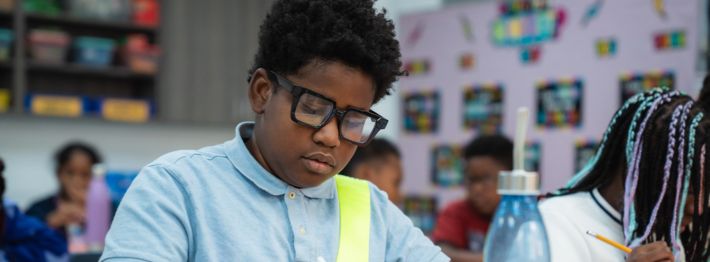 student focused on writing in class