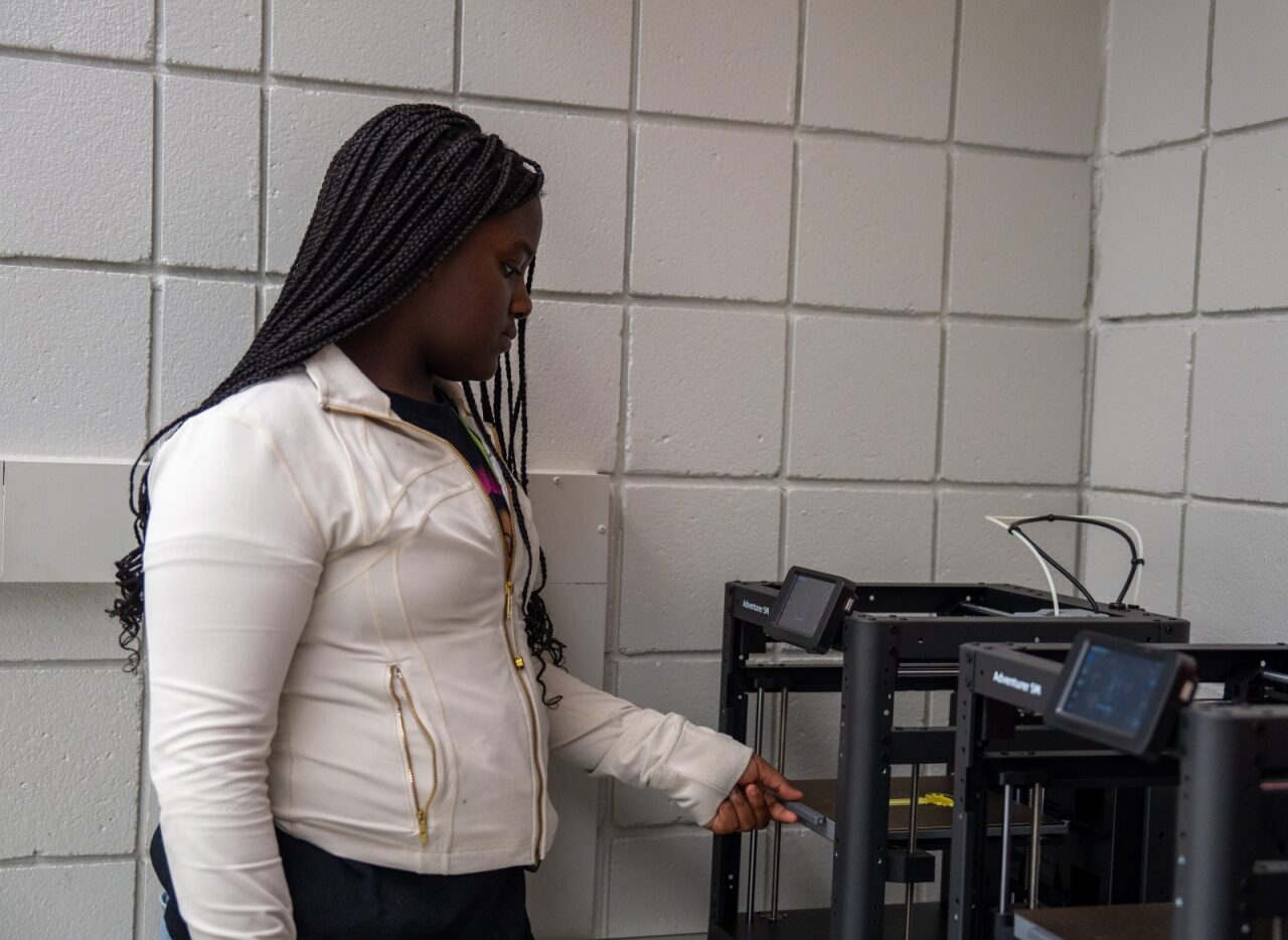 A student using a 3D printer