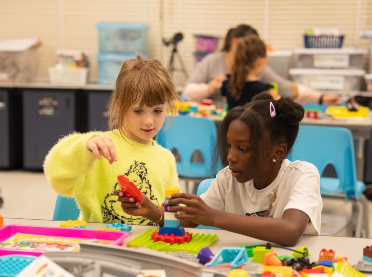 Two students playing with legos