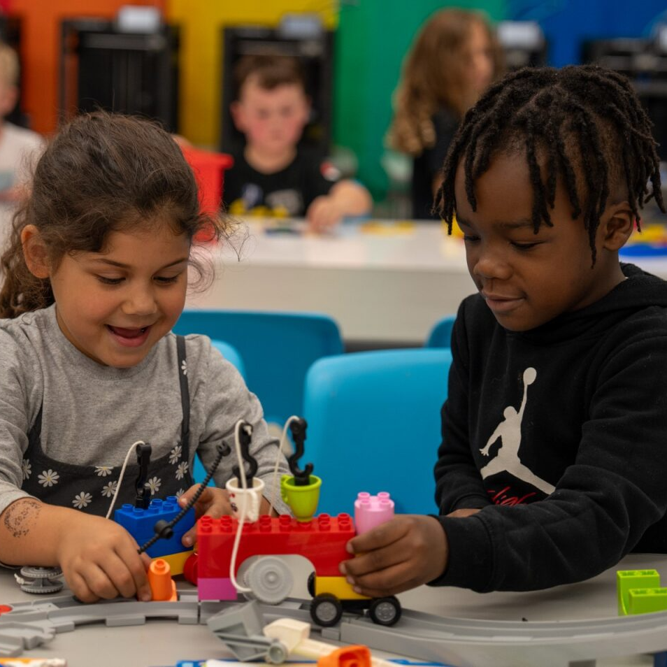 Two students playing with legos