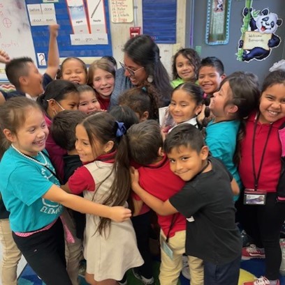 students hugging principal