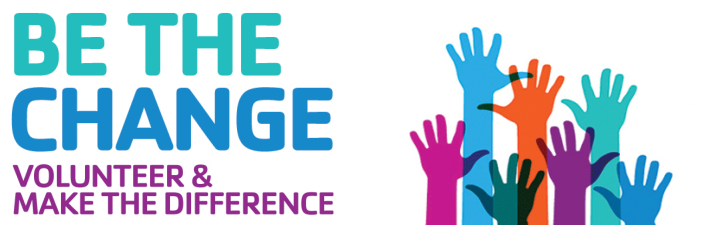 A colorful poster with the slogan 'BE THE CHANGE' at the top, featuring hands reaching out to each other and a call for volunteers to make a difference.