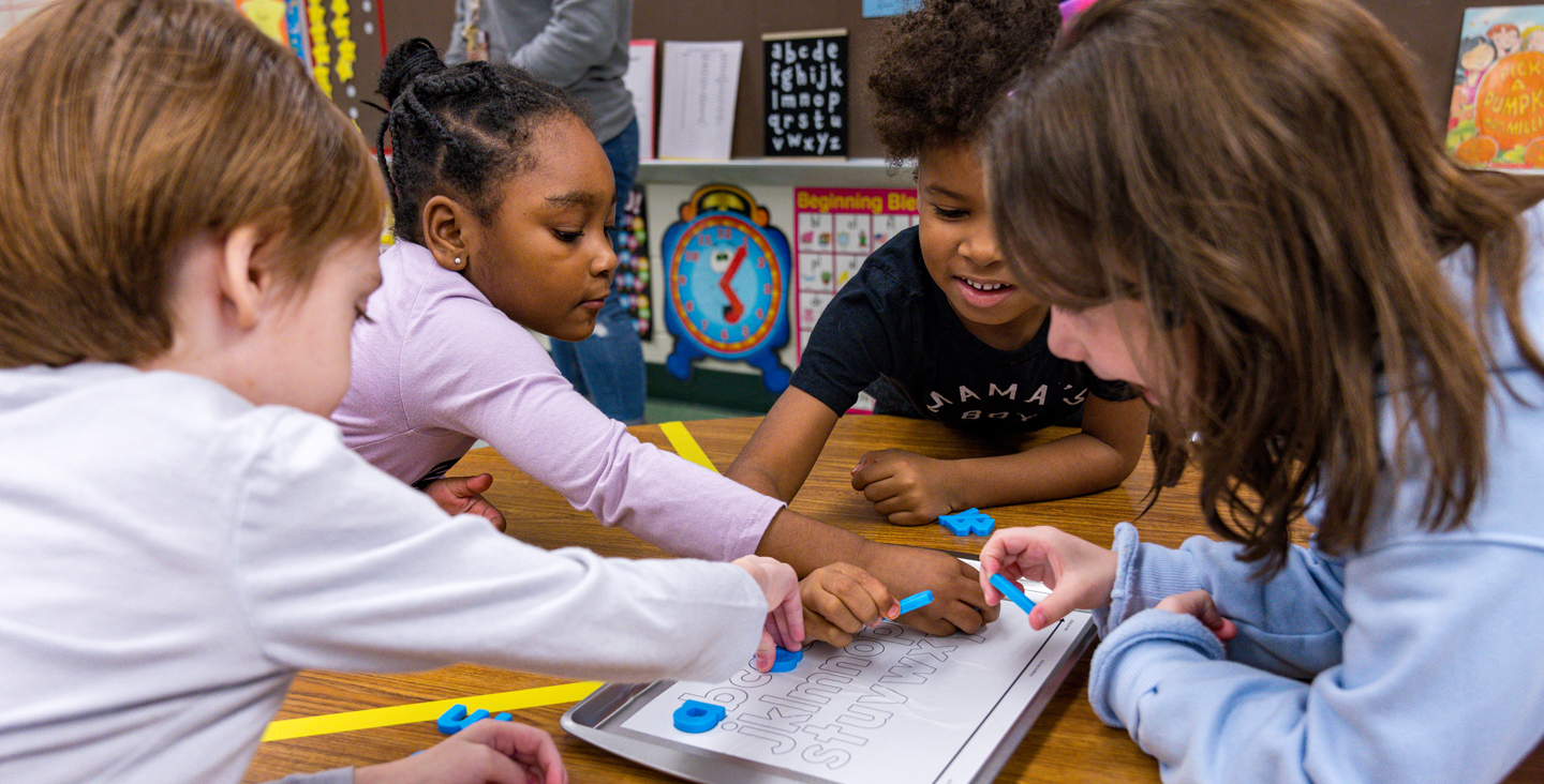 Students working together on the alphabet