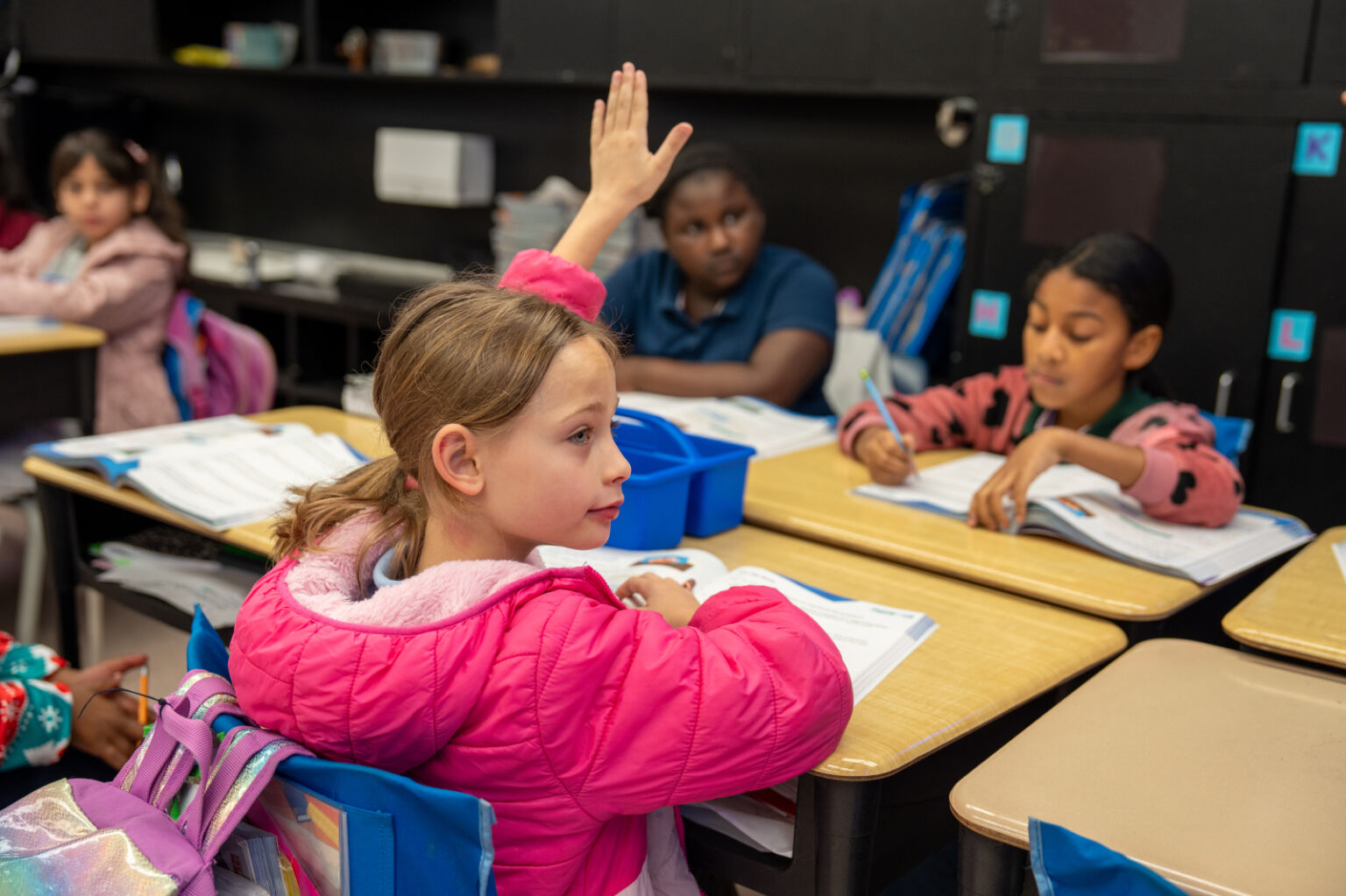 student raising her hand