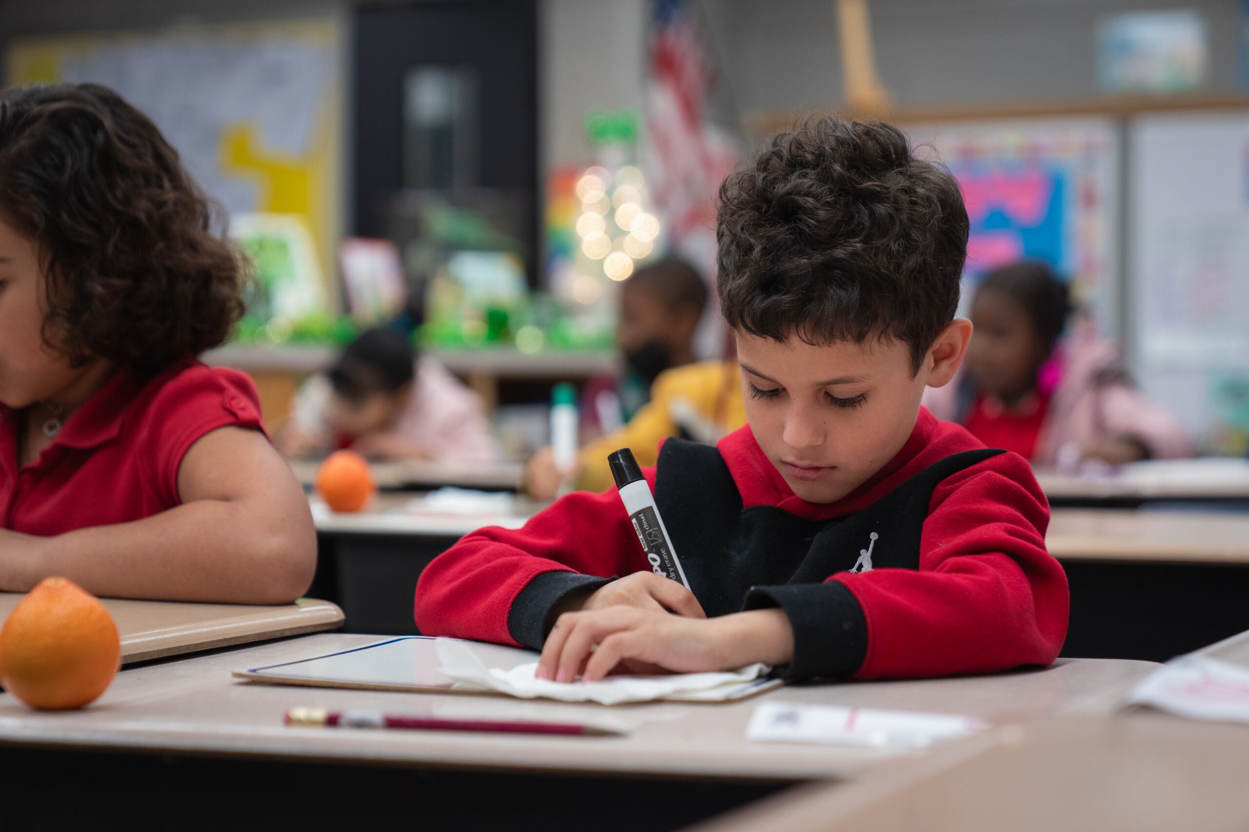 Student writing on his white broad