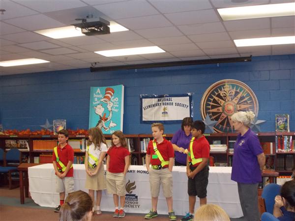 School children receiving awards for their achievements.