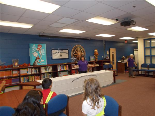 Individuals participating in a presentation or demonstration in a school or library setting.