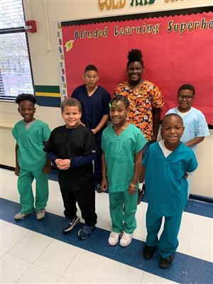 students in scrubs smiling