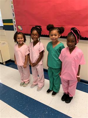 students in scrubs smiling