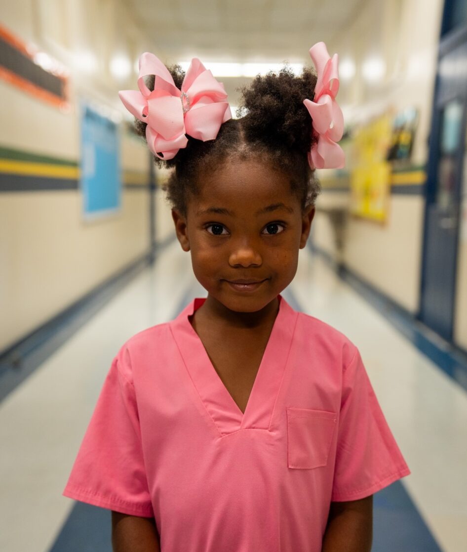 Student in scrubs smiling