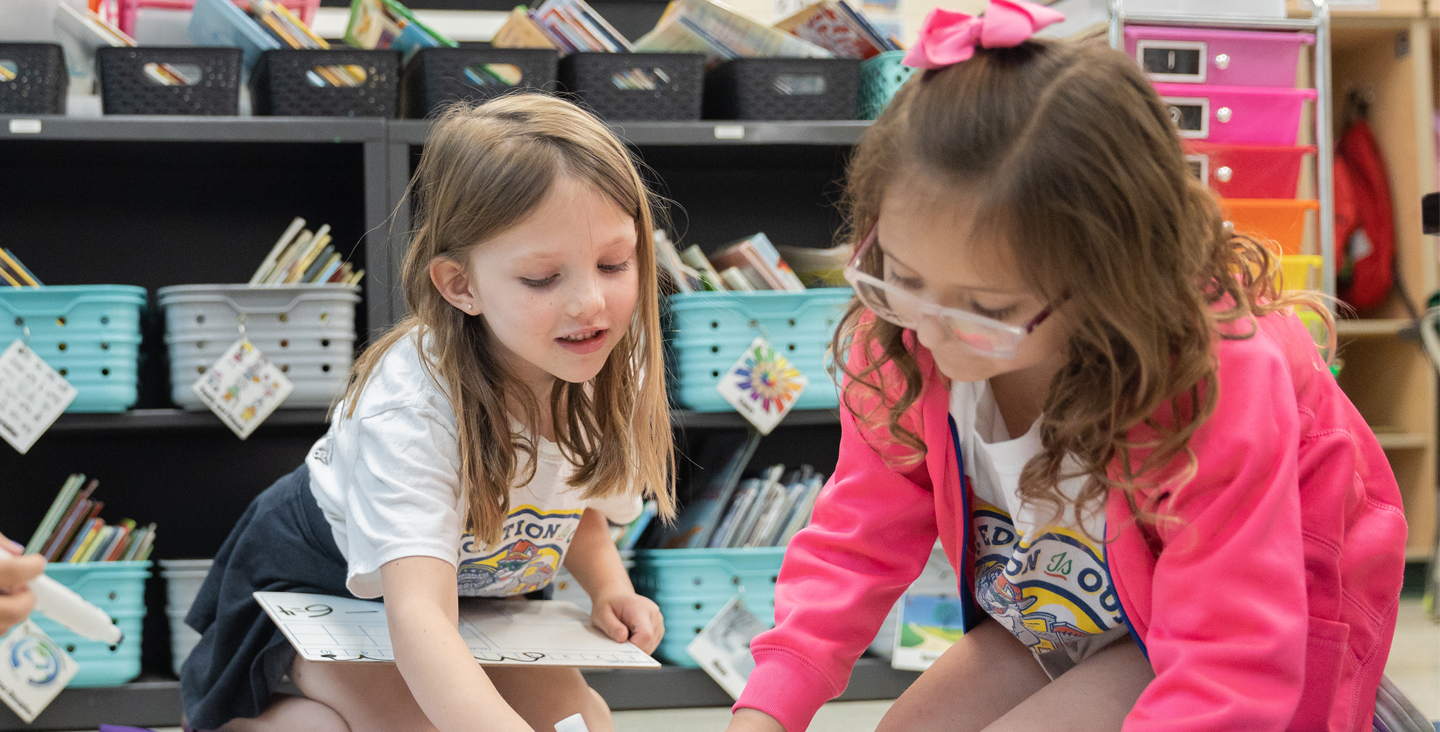 two students working together in a classroom