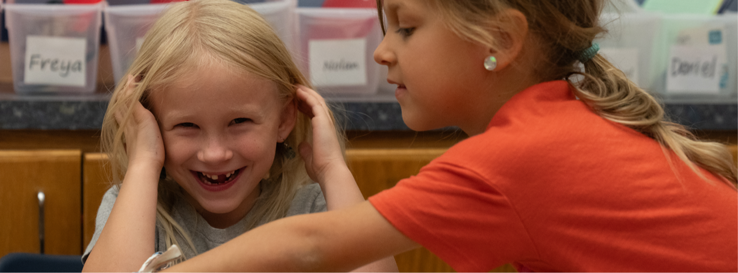 2 students laughing