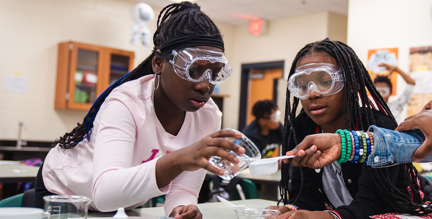 two students working on a science experiment