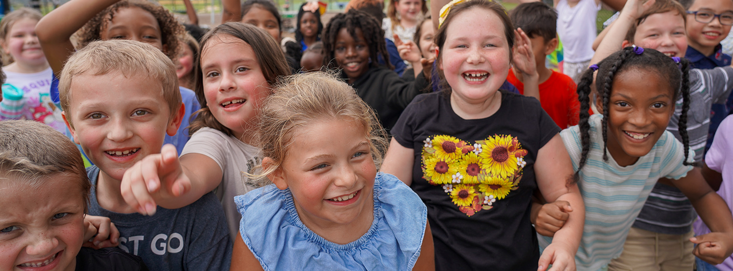 students smiling for the camera on a playground