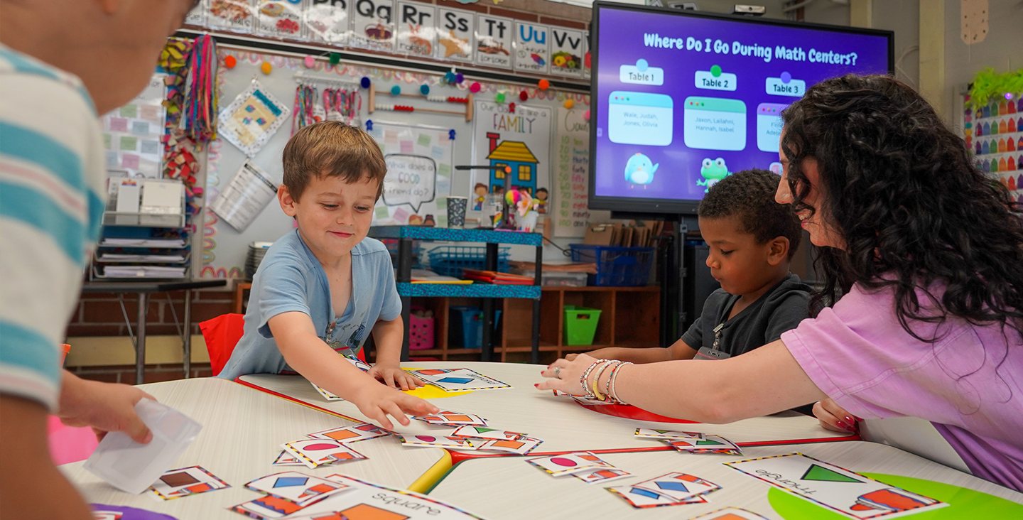 Children working with flashcards to learn shapes