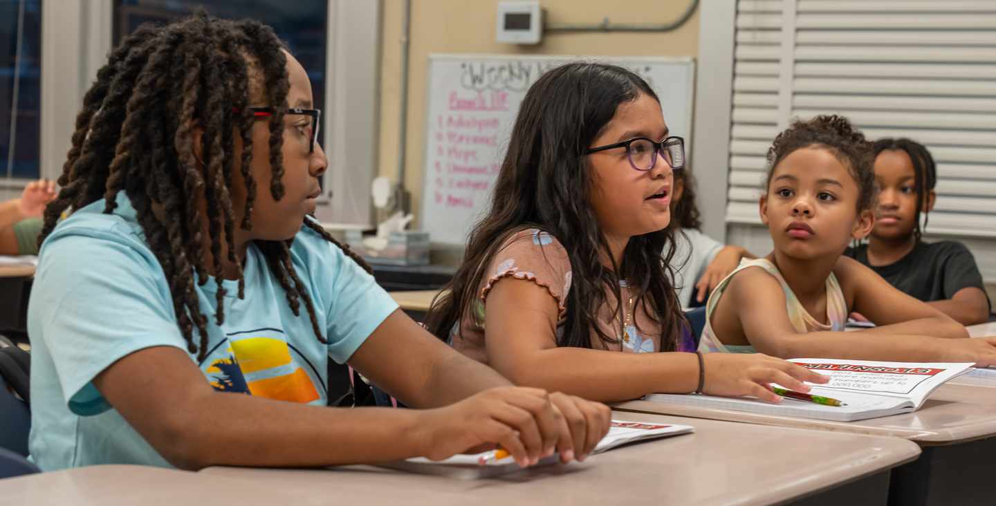 students listening to a peer ask a question in class