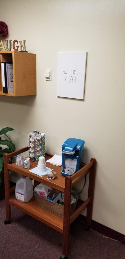 A tidy office corner with a bulletin board.