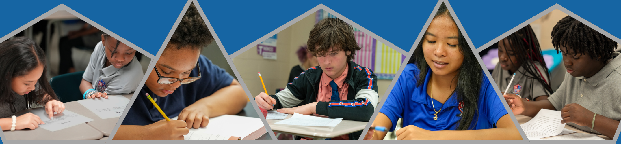 Five students sitting at their desks, working.