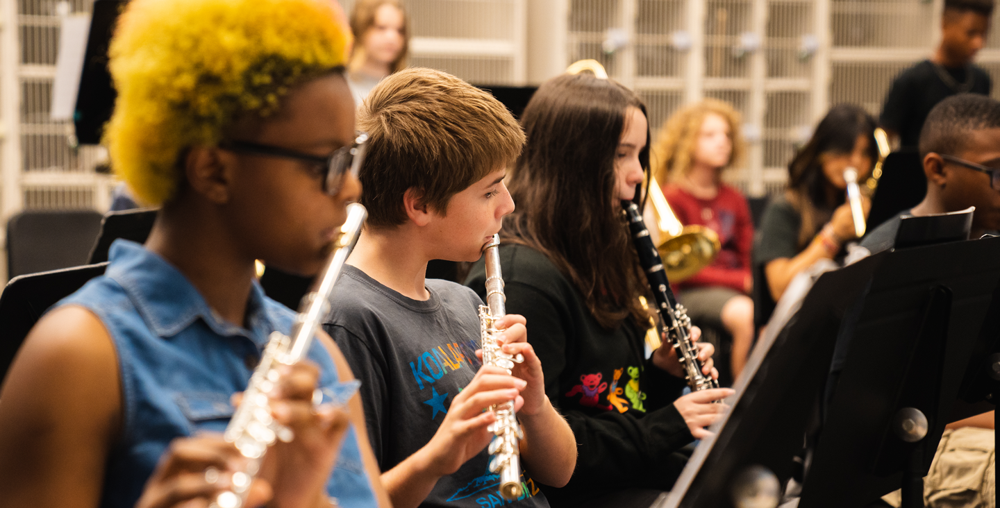 students playing flute and clarinet in band class