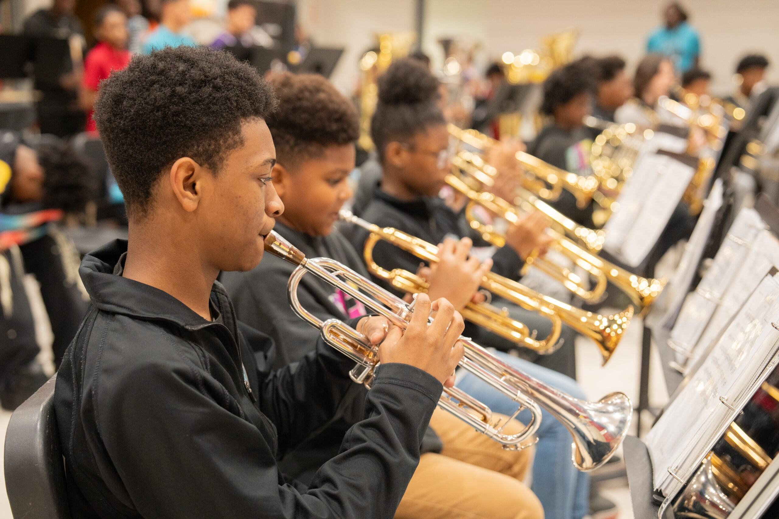 Students in a line playing the trumpet