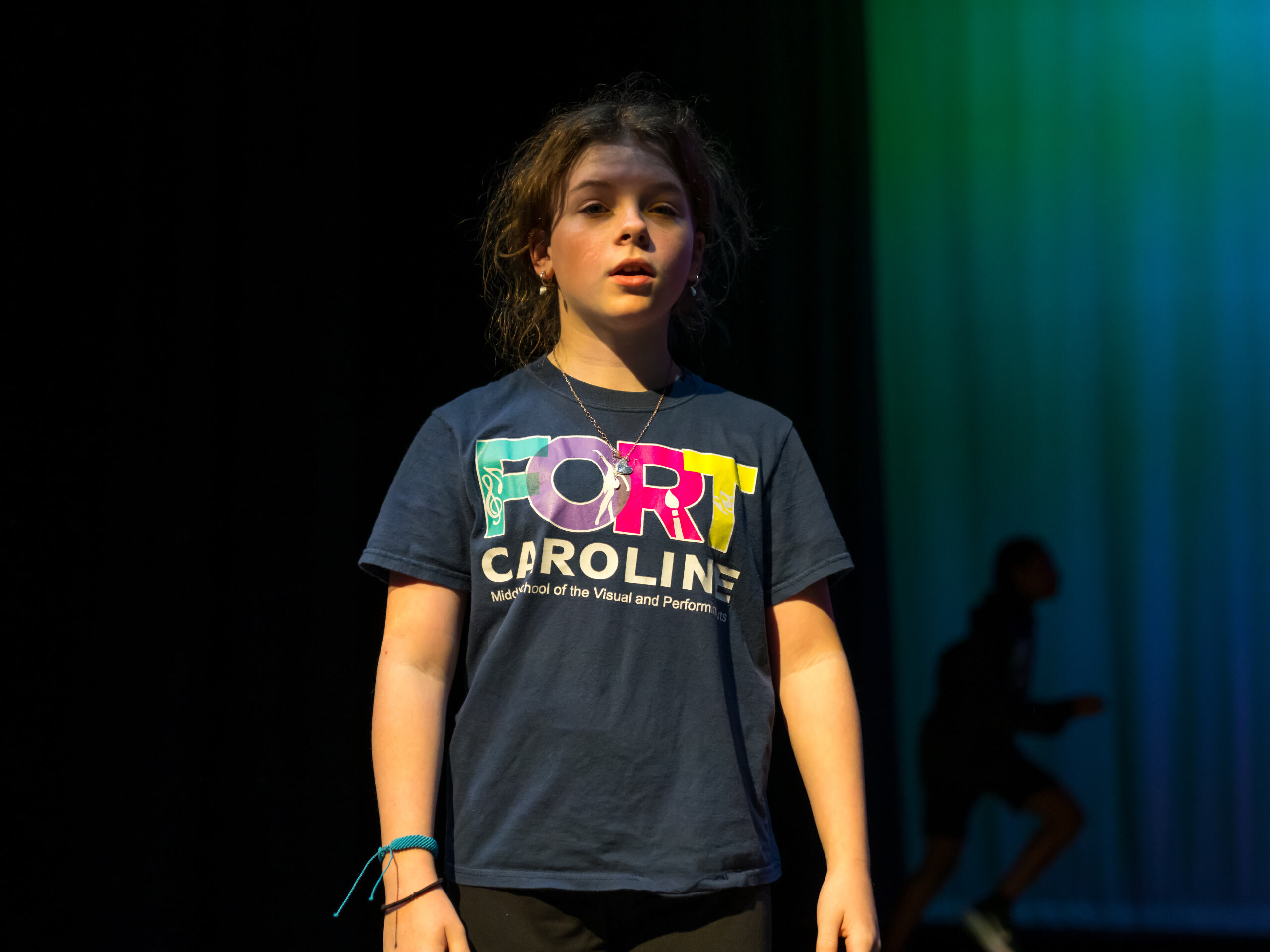 A student on stage singing
