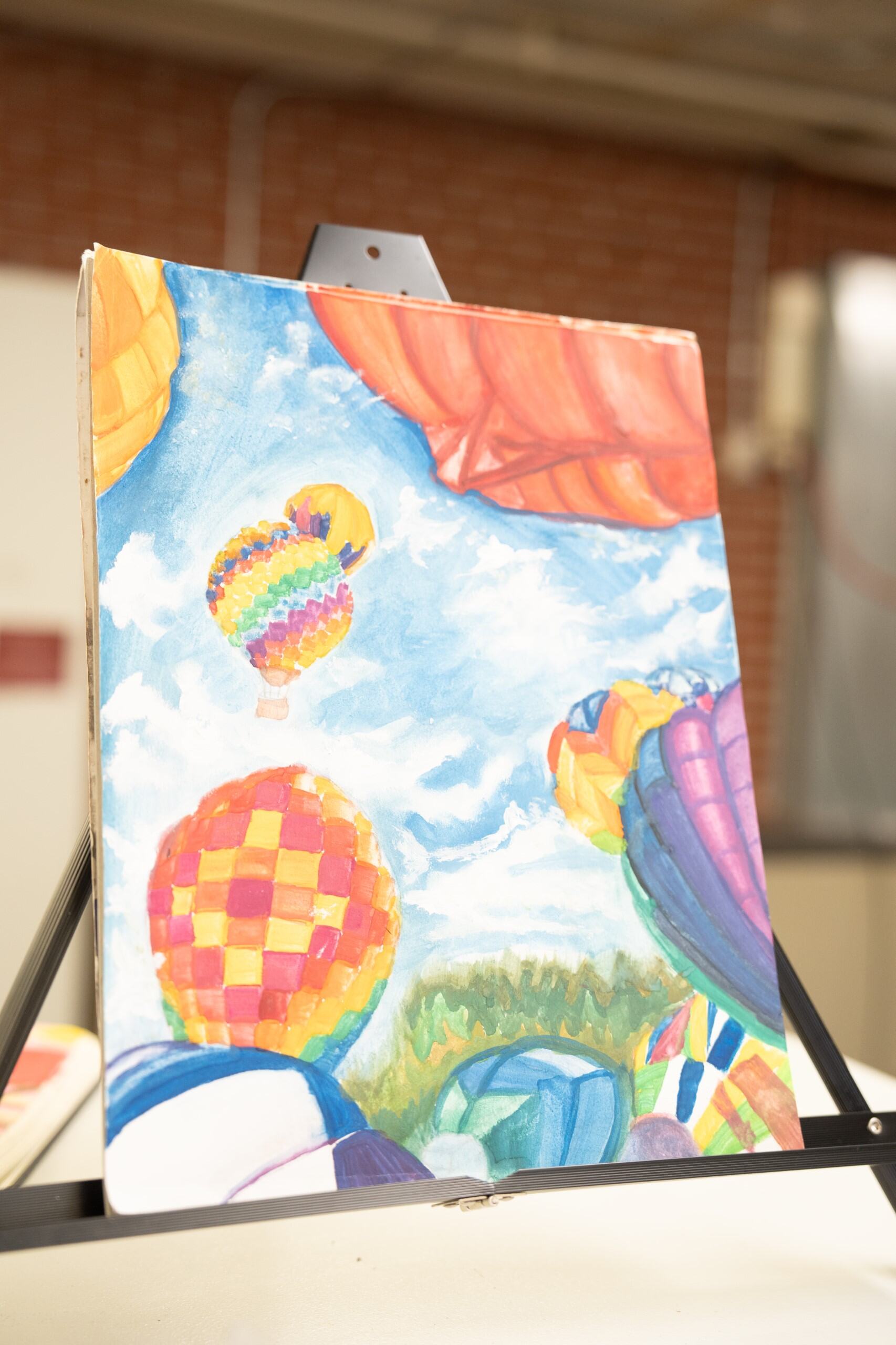 Student painting of hot air balloons in the sky