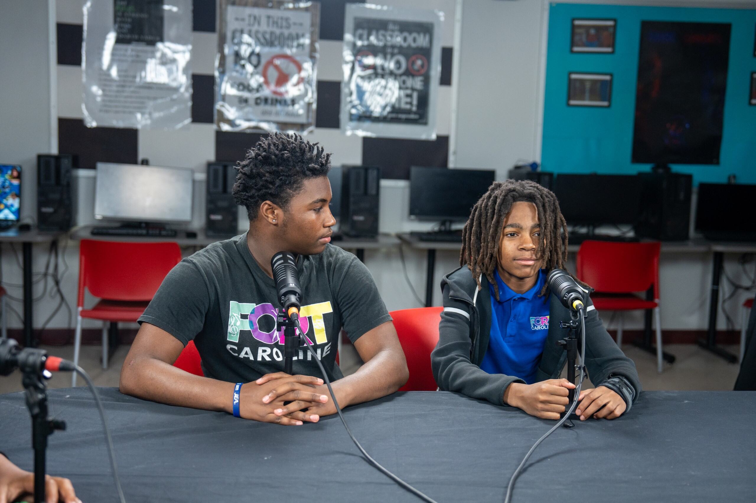 Two students speaking on a podcast together