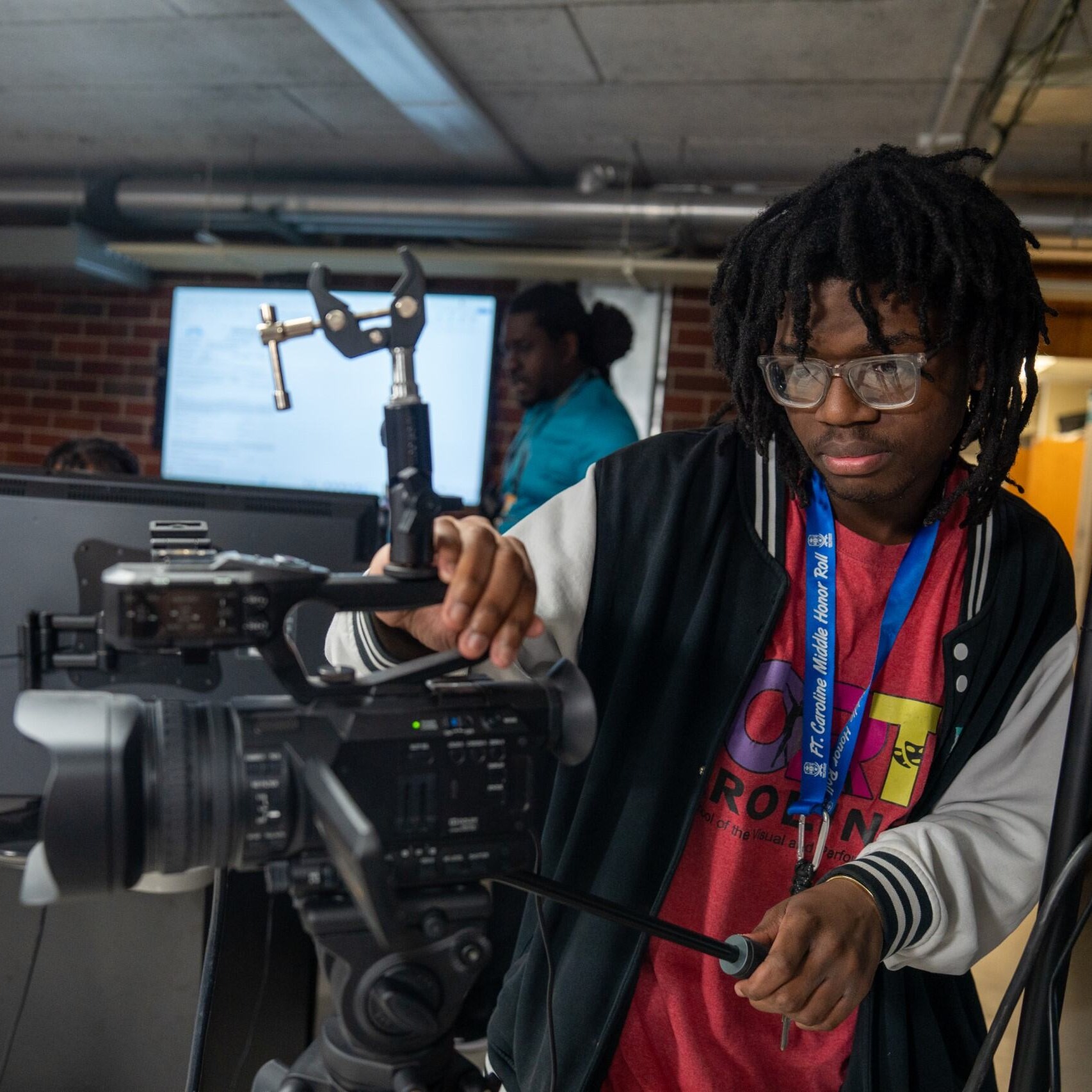 Student filming a podcast