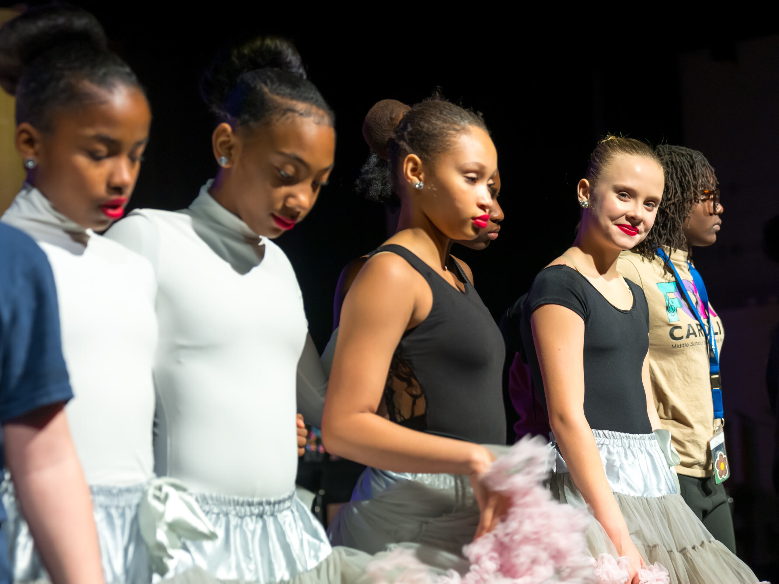 students in a line on stage