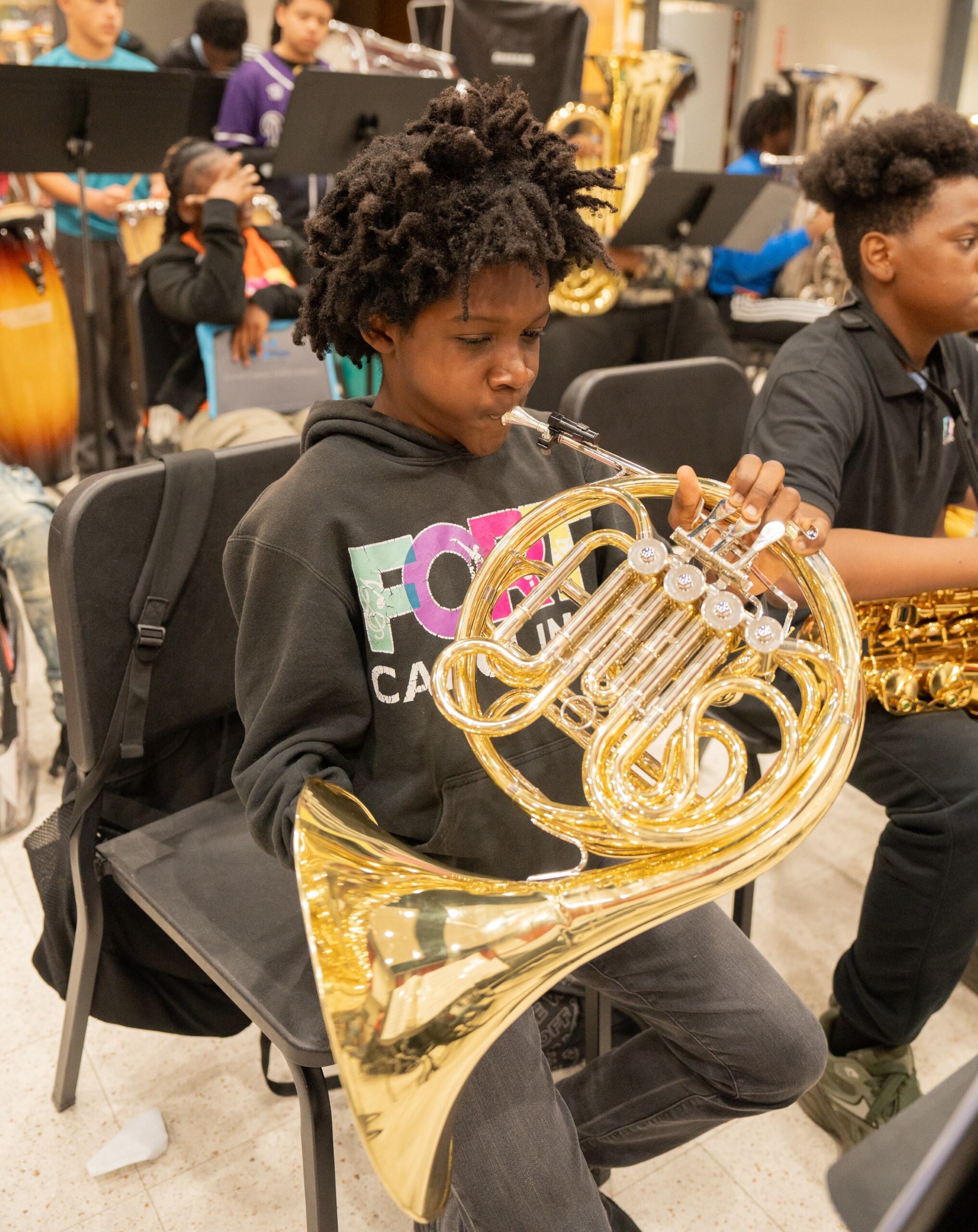 Student playing french horn